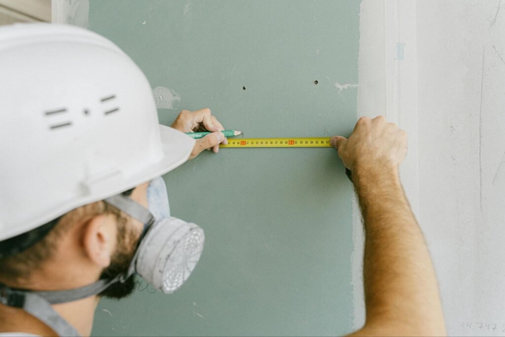 Man measuring drywall